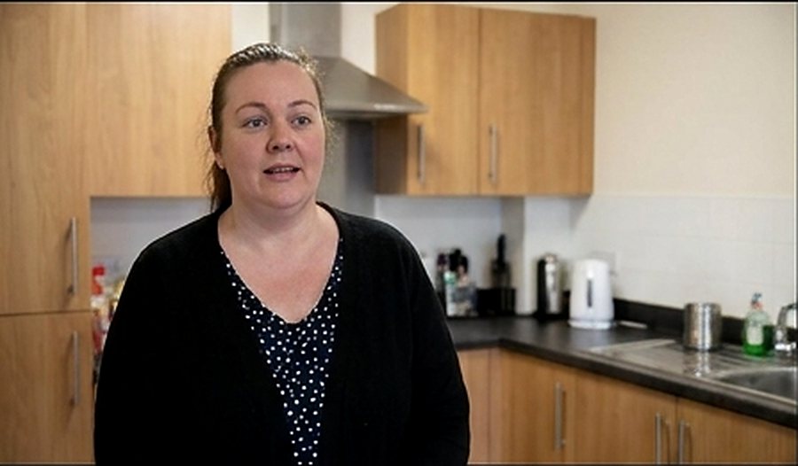 A service manager speaking in a staff kitchen